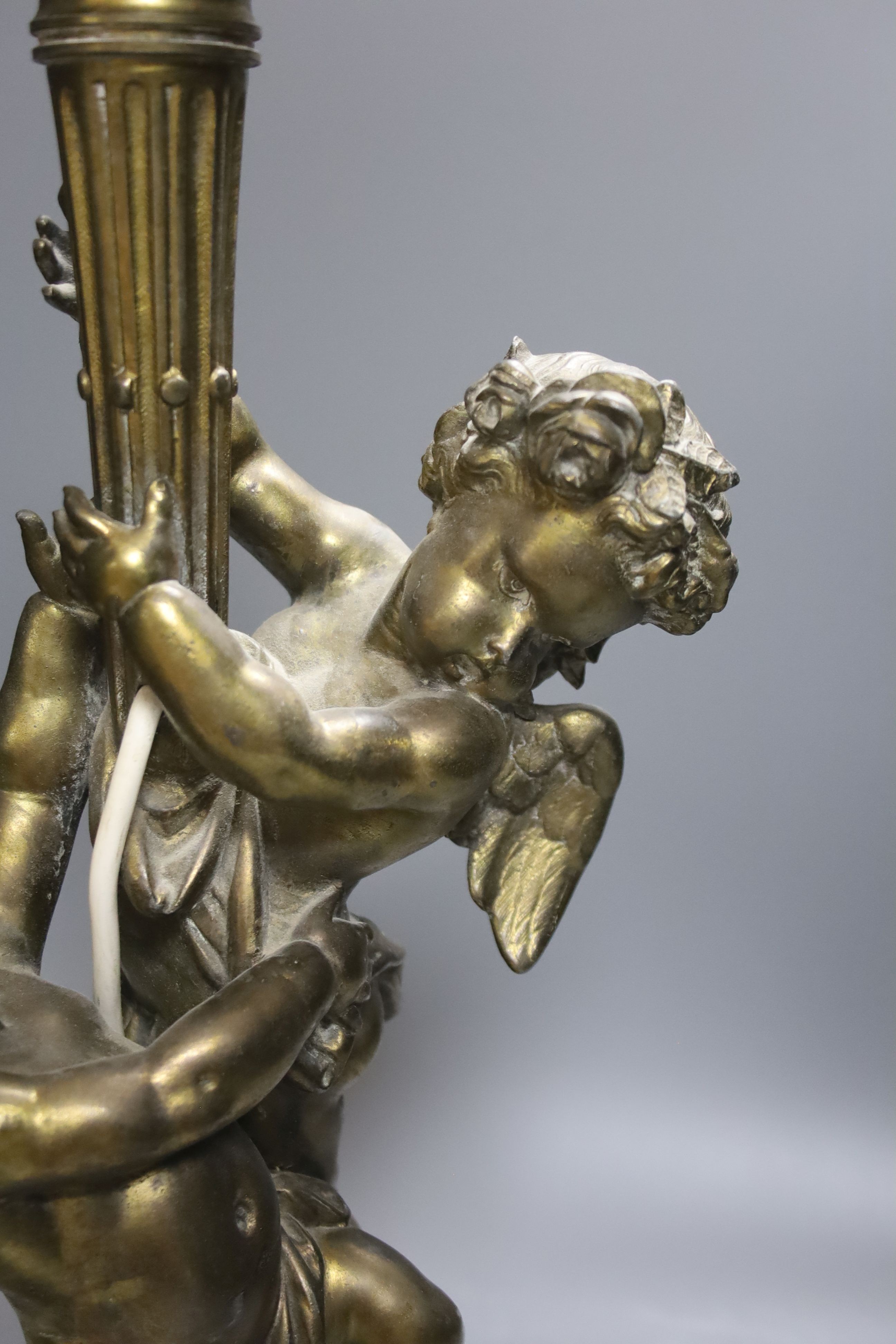 A gilt metal cherubic table lamp, signed, overall height 50cm